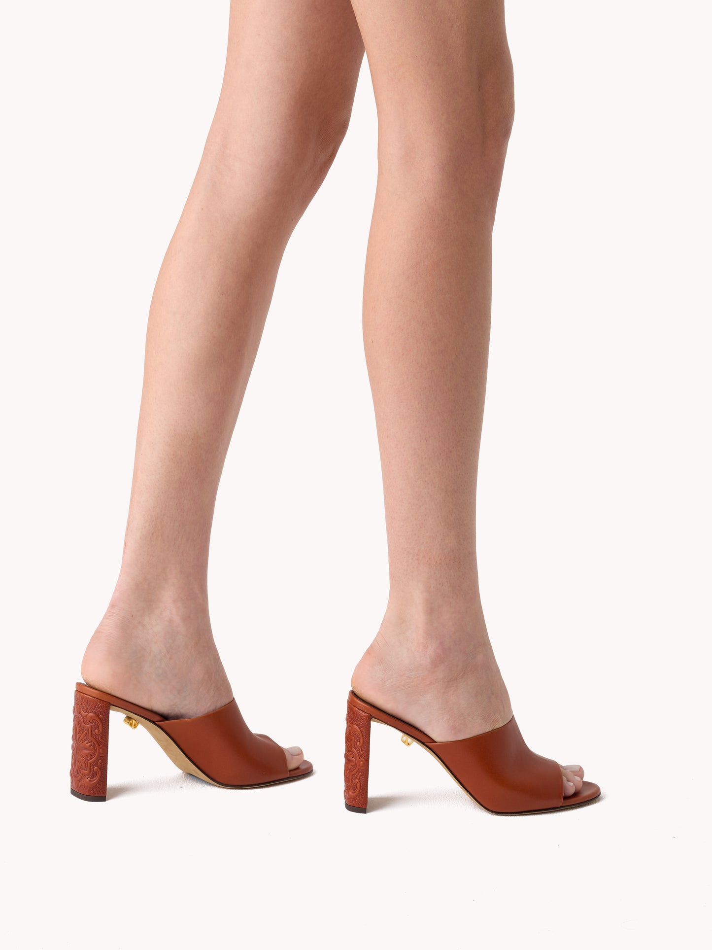 Luxury leather brown mules with embossed heels maison skorpios by adriana abascal emanuele filiberto