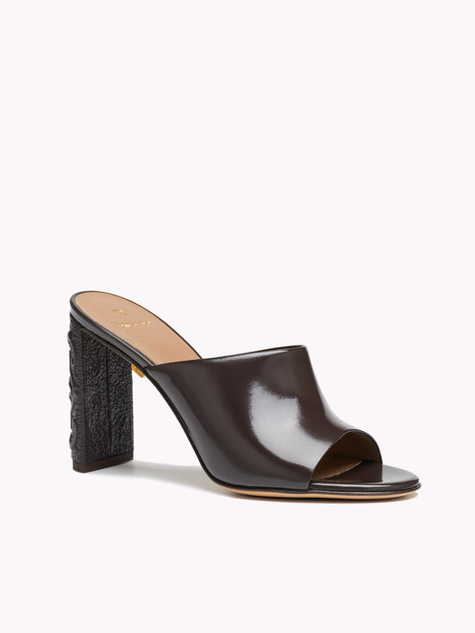 Patent brown leather mules Maison Skorpios by Adriana Abascal